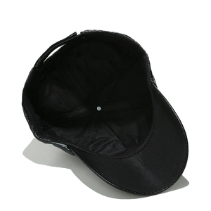 Detailed interior of a black faux leather baseball cap showing stitching and glossy finish