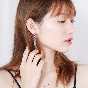 Long silver chain tassel earrings with LOVE letter charms worn by a model on white background