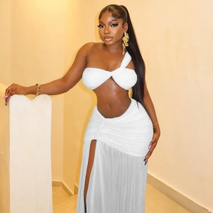 Detail of white two-piece set featuring a knot crop top and high slit maxi skirt
