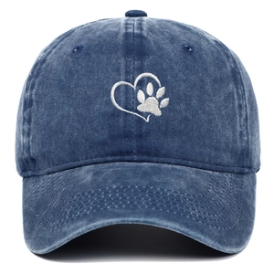 Detailed embroidery of white heart and paw print on navy washed cotton baseball cap