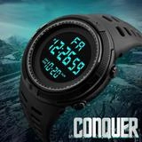 Rugged black digital sports watch with stopwatch and date display on outdoor mountain rock