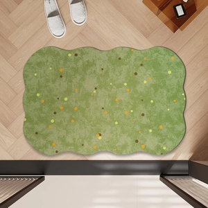 French style green wavy diatom mud bath mat with orange dots on wood floor