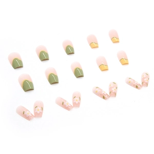 Pastel yellow and green press-on nails with white floral patterns and glossy finish