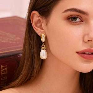 Elegant gold drop earrings with micro-pave diamonds and pear-shaped pearls for women