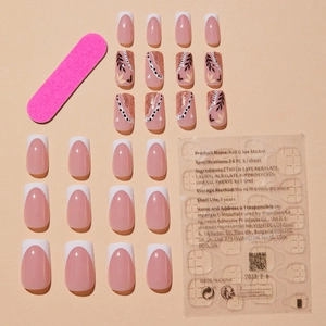 French press-on nail set with leaf patterns and glitter gold details in warm tones