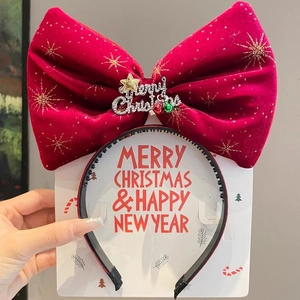 Detail of red velvet Christmas headband with gold snowflake sequins and Merry Christmas bell