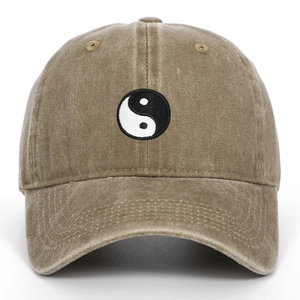 Macro detail of Tai Chi embroidery on khaki washed cotton baseball cap texture