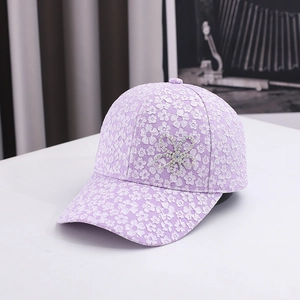 Light purple baseball cap with white floral lace patterns and rhinestone flower accent