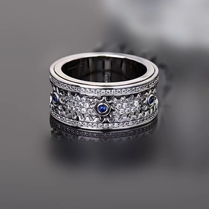 Macro shot of mechanical gear ring with blue stones and rows of pavé diamonds