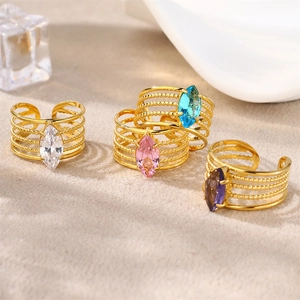 Detail of gold-plated stainless steel rings with colorful marquise-cut zircons and beads