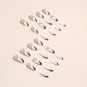 Almond-shaped press-on nails in monochrome black and white with gold glitter accents