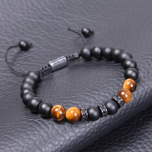 Tiger eye and matte stone beaded bracelet with zircon spacers on black leather surface
