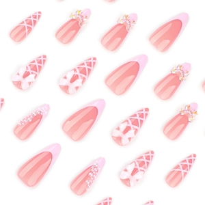 Pink French press-on nails with 3D bows and pearls on a white background