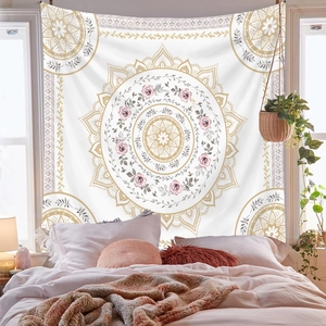 Detail of bohemian mandala tapestry featuring golden patterns and pink floral prints