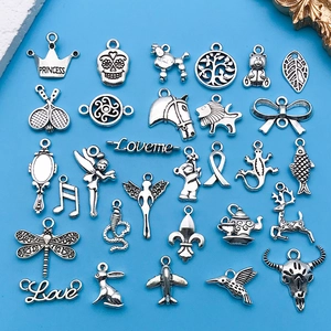 Set of 28 vintage silver alloy charms featuring animals and symbols for DIY jewelry