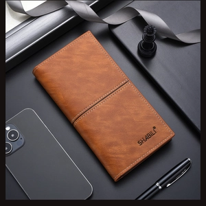 Close-up of brown textured PU leather wallet with white stitching and branding detail