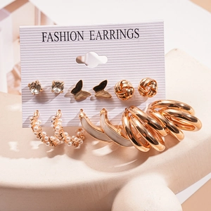 Detailed set of nine gold-tone earrings with pearls and butterflies on display card