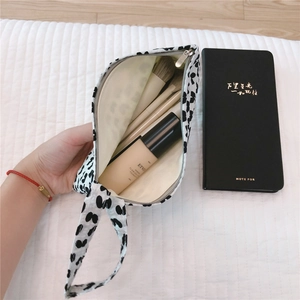 Detailed interior storage of the leopard print mini fabric tote with cosmetics