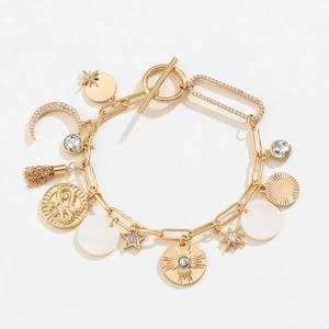 Gold multi-charm bracelet featuring celestial stars, moon, and sun coins with T-bar clasp