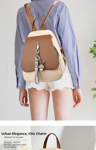 Detail of a stylish two-tone cream and brown backpack with cute rabbit charm and metal zipper