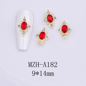 Detail of red oval gemstone nail charm with gold rhombus frame and white crystals