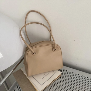 Minimalist beige leather Boston tote bag with double handles for a classic commute