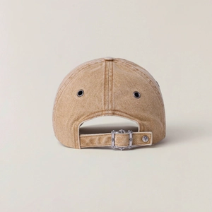Close-up of khaki washed denim cap back with adjustable metal buckle and vent holes
