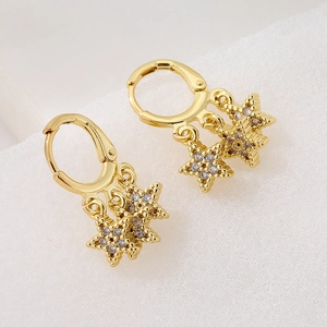 Gold-plated 18K star hoop earrings with clear zircon charms on white textured fabric