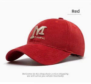 Close-up of 3D embroidered white M logo on a premium red twill cotton baseball cap