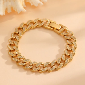 Detail of gold Cuban link bracelet with sparkling rhinestones and a fold-over clasp