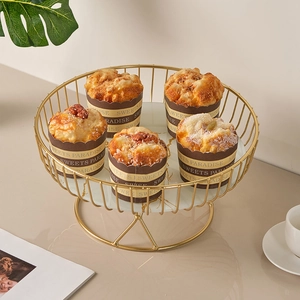 Golden wire fruit basket with white marble base for snacks and dessert display