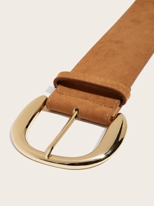 Detail of premium brown suede belt with a polished golden metal buckle on beige background