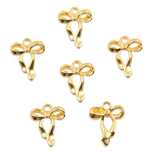 Detailed view of six glossy gold bow alloy charms for DIY jewelry making on white background