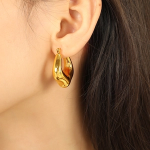 French vintage titanium steel U-shaped hollow hoop earrings worn by a female model