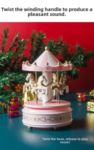 Detail of a pink carousel music box with golden accents set against festive decor