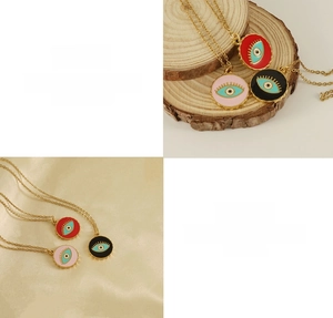 Close-up of 18K gold plated titanium evil eye pendants in red, pink and black colors