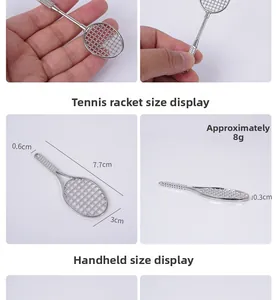 Mini silver metal tennis racket keychain model with detailed size dimensions of 7.7cm by 3cm