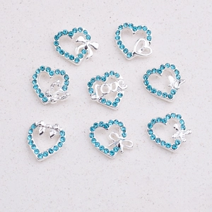 Detail view of light blue heart and butterfly charms with silver alloy plating