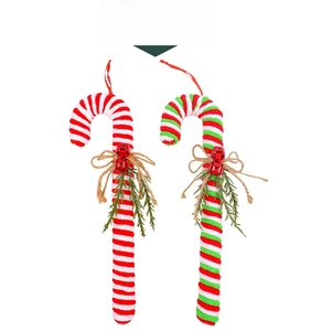 Detail of red and white striped candy cane ornaments with bells and pine needles