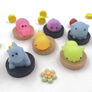 Top view of colorful TPR soft squishy animal toys on round wooden display bases
