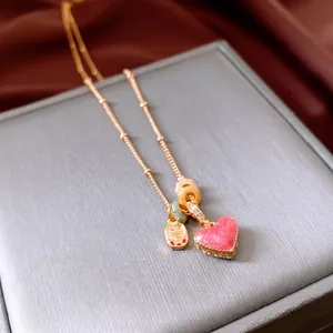 18k gold plated necklace featuring pink heart pendant and traditional Chinese charm