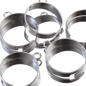 Adjustable stainless steel ring bases for DIY jewelry making scattered on white background