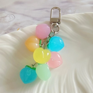 Macro shot of colorful resin heart-shaped pendants on a metal keychain chain