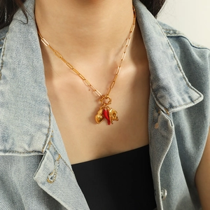 Vintage gold layered necklace featuring red chili heart and rock hand gesture charms