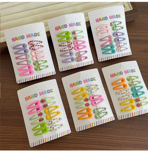 Flat lay of 60 mini fruit pattern hair clips on display cards for girls