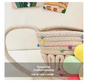 Close-up of beige woven children crossbody bag with colorful flower charms and stitching