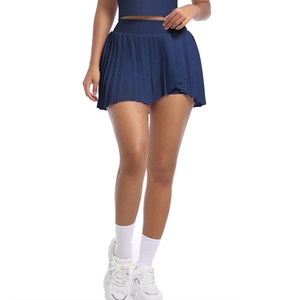Detail of high-waist pleated sports skirt with wide waistband and inner safety shorts