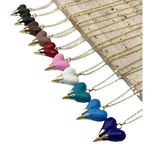 Elegant gold chain necklace set with heart pendants in ten assorted vibrant enamel colors