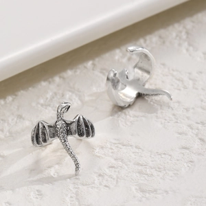 Vintage silver dragon ear cuffs with detailed scales and wings in a gothic style
