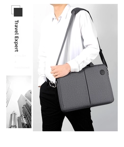 Close-up of a dark grey business laptop bag with premium fabric texture and shoulder strap